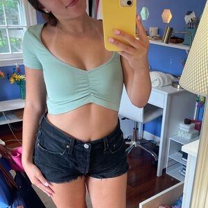 Urban outfitters out from under light green crop top.